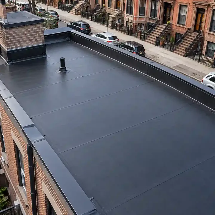 Newly installed EPDM rubber roofing membrane on a flat Brooklyn building, with clean seams, metal roof edging, and a residential street with parked cars in the background.